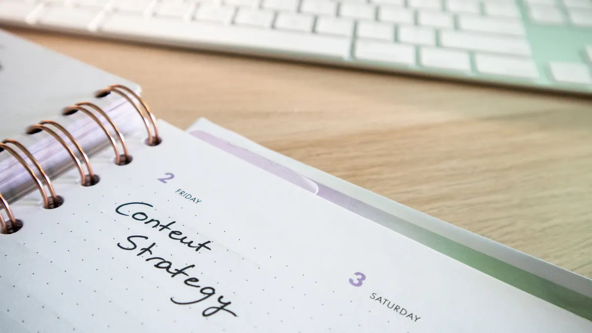 Planner page labeled content strategy on desk
