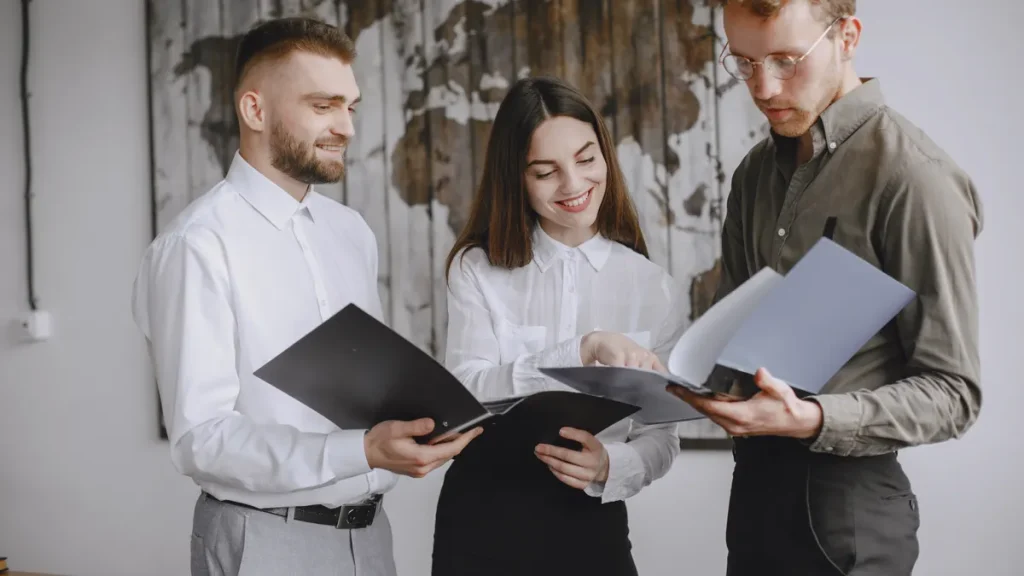 Three coworkers reviewing documents together