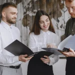 Three coworkers reviewing documents together