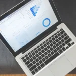 laptop showing analytics charts on screen